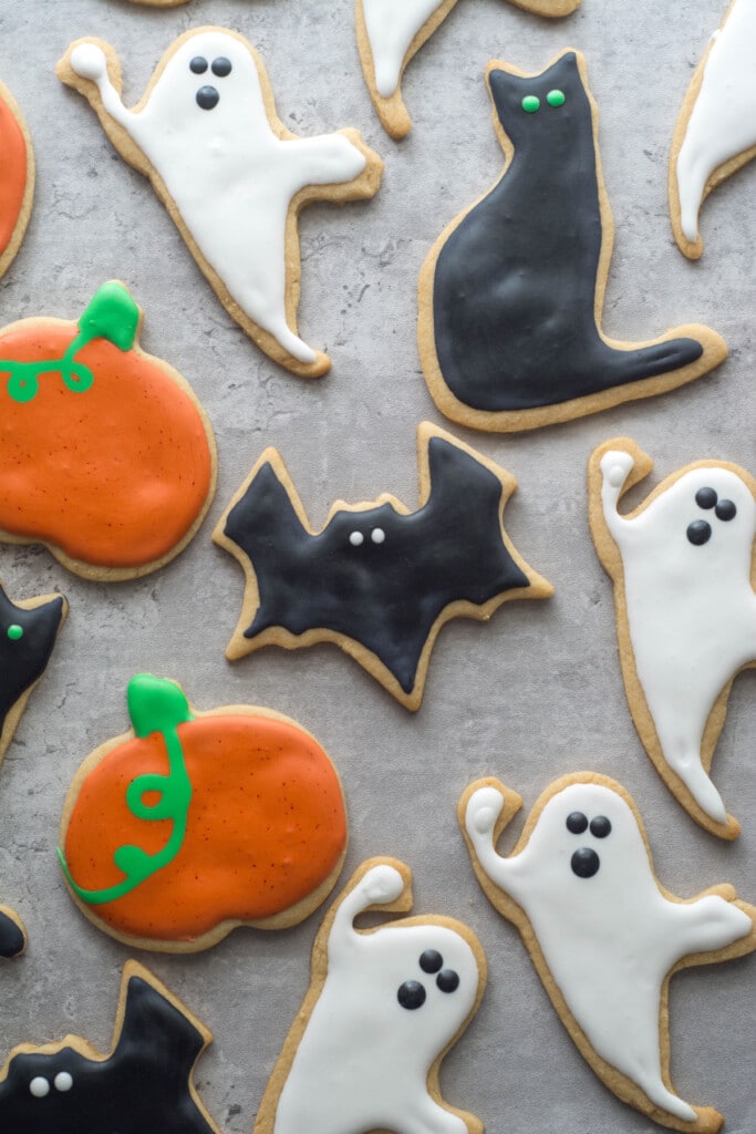 Frosted Halloween sugar cookies on a gray counter.